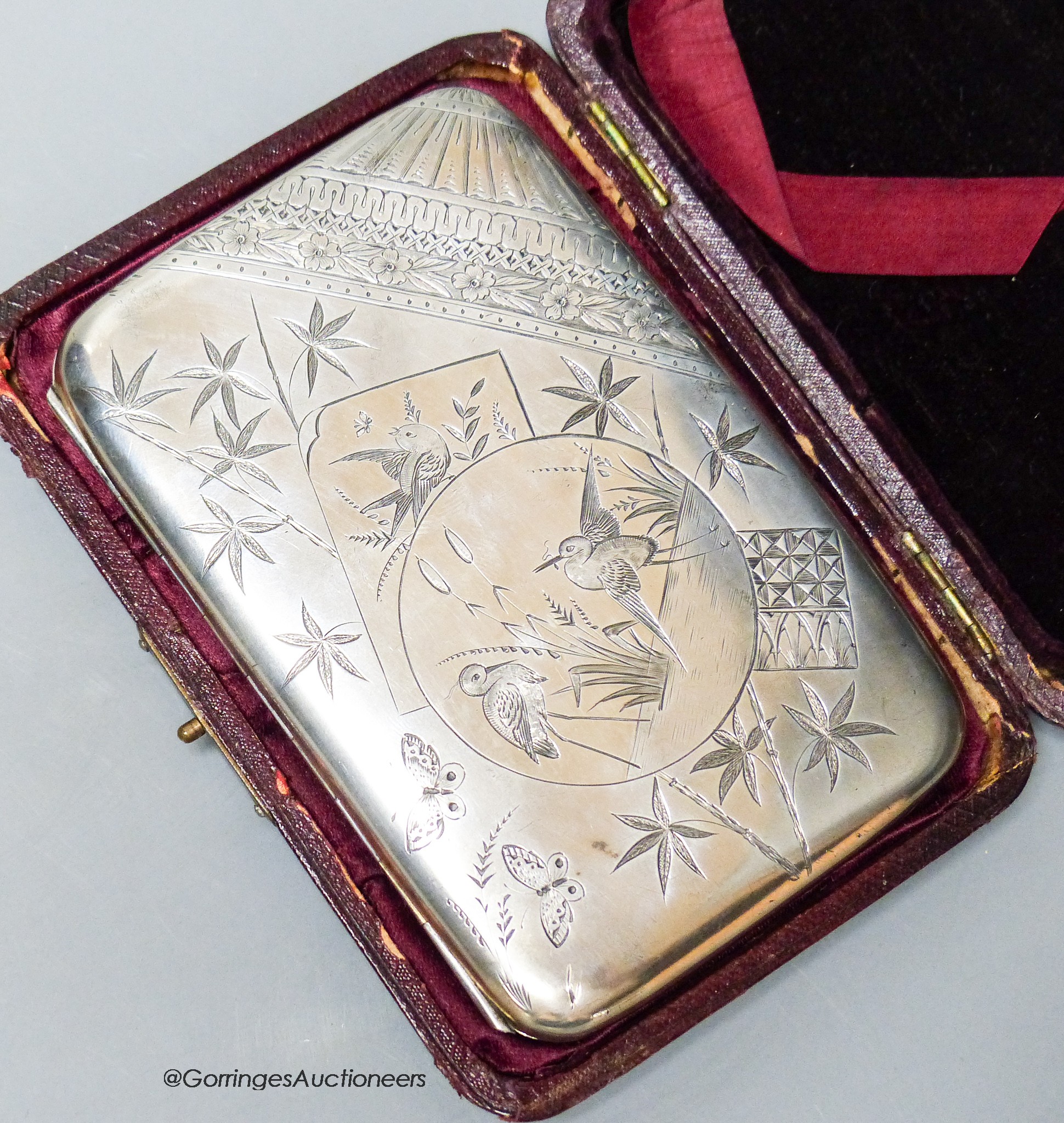 A Victorian silver mounted purse, with engraved aesthetic decoration, R.W & Co, Birmingham, 1884, 10.4cm, with leather case.